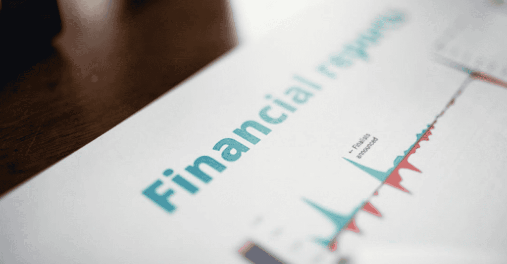 Close-up of a printed document titled Financial report, displaying colorful bar graphs with red and green segments, indicating financial data and trends.