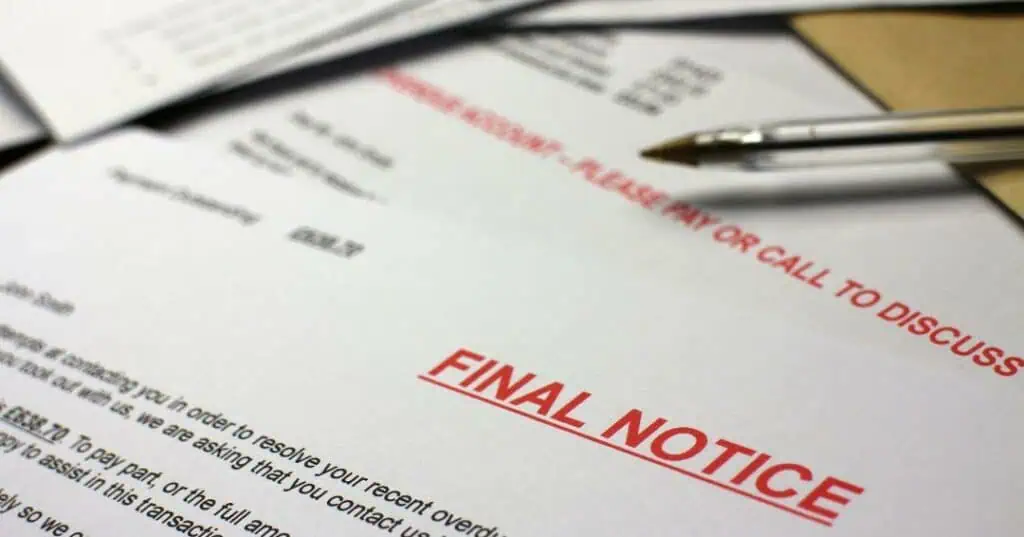 Overdue account letter stamped Final Notice in red, with a pen resting on the page